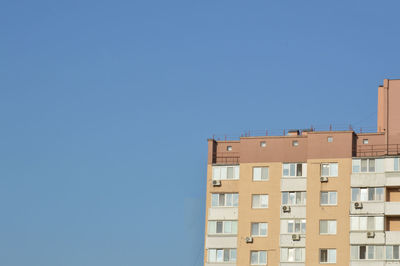 Low angle view of building against clear blue sky