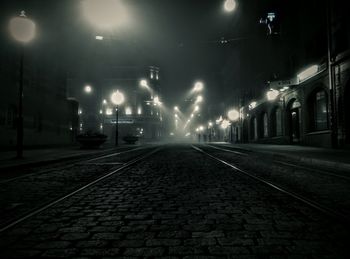 Street lights in illuminated city at night