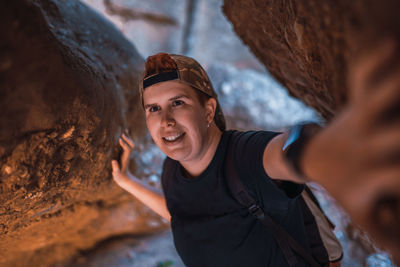 Woman standing by rock