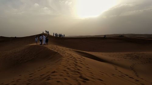 Scenic view of desert against sky during sunset