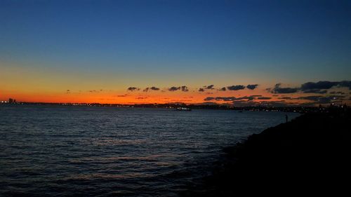 Scenic view of sea against clear sky during sunset