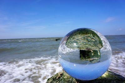 Close-up of sea against blue sky