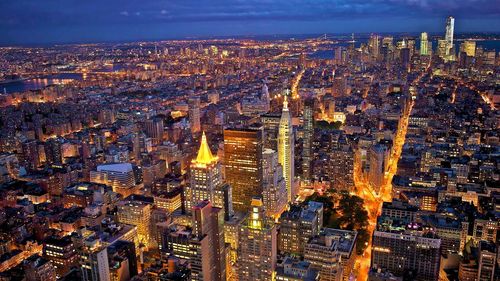 High angle view of city lit up at night