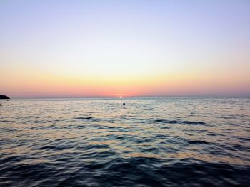 Scenic view of sea against clear sky during sunset