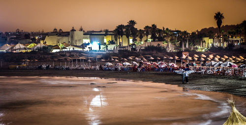 Parasols at beach during sunset