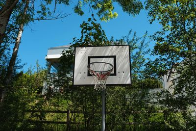 Low angle view of basketball hoop against blue sky