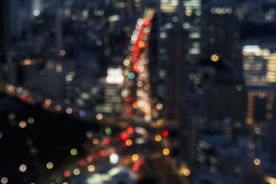 Defocused image of illuminated city at night