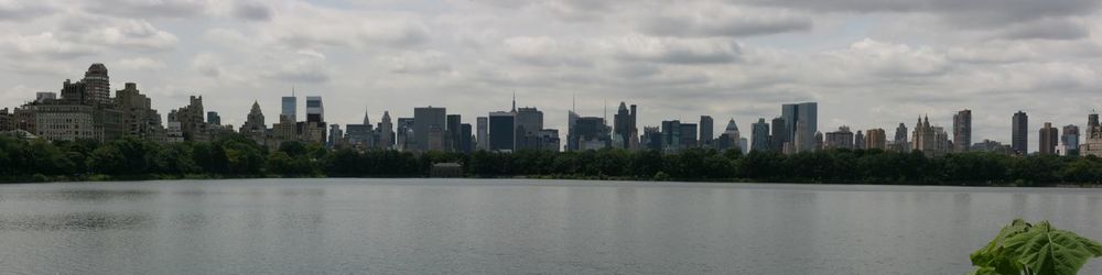 View of cityscape against cloudy sky