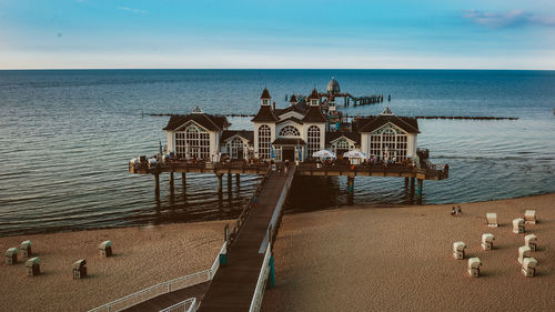 View of pier on beach against sky