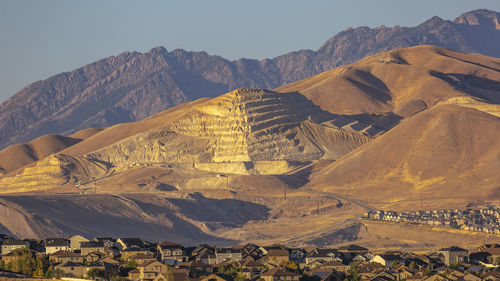 Aerial view of a town with mountain range in background