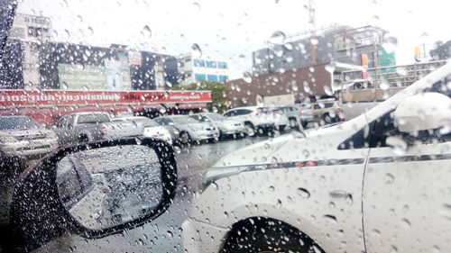 Aerial view of city seen through wet windshield