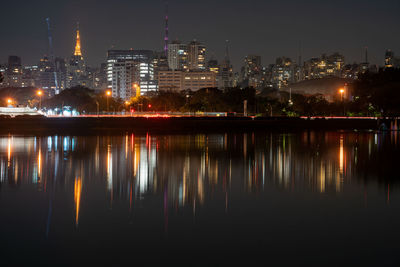 Reflection of buildings in city at night