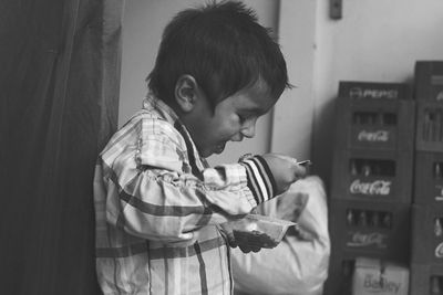 Cute boy having food at home