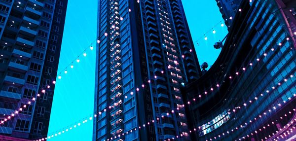 Low angle view of modern buildings against sky at night