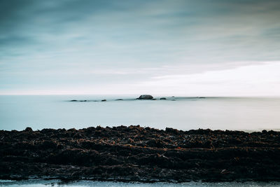 Scenic view of sea against sky at sunset