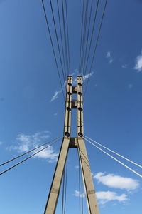 Low angle view of cables against blue sky