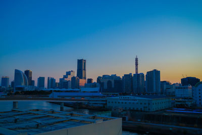 Cityscape against clear blue sky