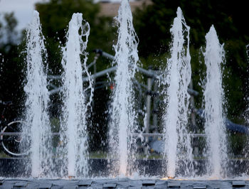 Water splashing on fountain against trees