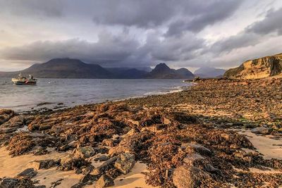 Scenic view of mountains against cloudy sky