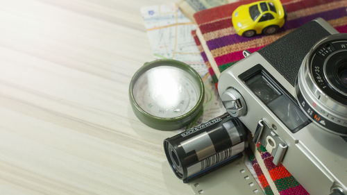 High angle view of technologies and travel equipment on wooden table