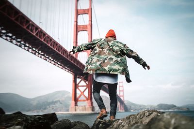 Rear view of man standing on rock