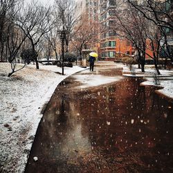 Man on wet road during winter