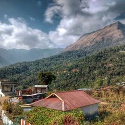 Scenic view of mountains against cloudy sky