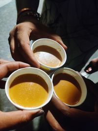 High angle view of hand holding tea cup