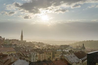 Cityscape against cloudy sky