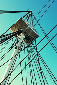 Low angle view of windmill against clear blue sky