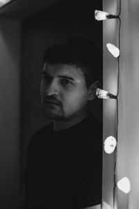 Portrait of young man looking through camera