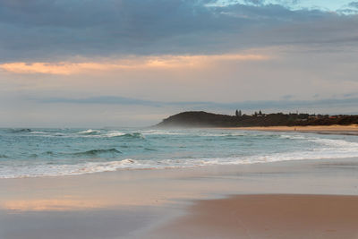 Scenic view of beach against sky during sunset