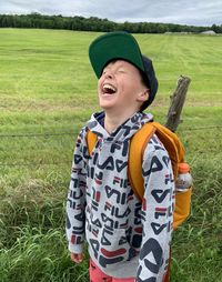 Portrait of young woman standing on field