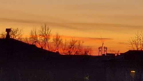 Silhouette of building against sky during sunset