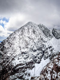 Low angle view of snowcapped mountain against sky