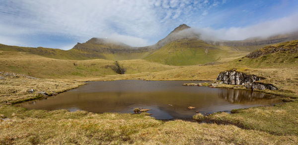 Scenic view of lake and mountains against sky