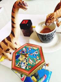 High angle view of toys with coffee cup on table