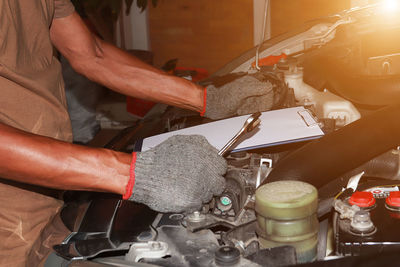 Midsection of man working in kitchen