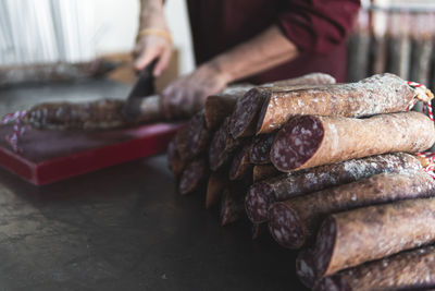 Butcher cutting pork meat in slaughterhouse