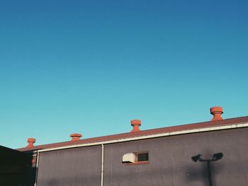 Low angle view of built structure against clear blue sky