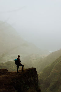 Full length of woman standing on mountain