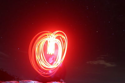 Illuminated light painting against star field at night