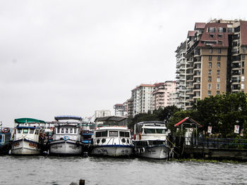 Boats in river with buildings in background