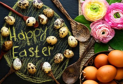 High angle view of eggs by text on table during easter