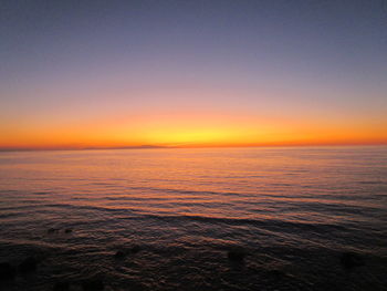 Scenic view of sea against clear sky during sunset