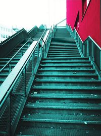 Low angle view of staircase amidst buildings in city