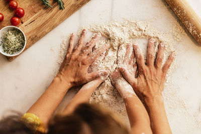 High angle view of mother and child preparing food