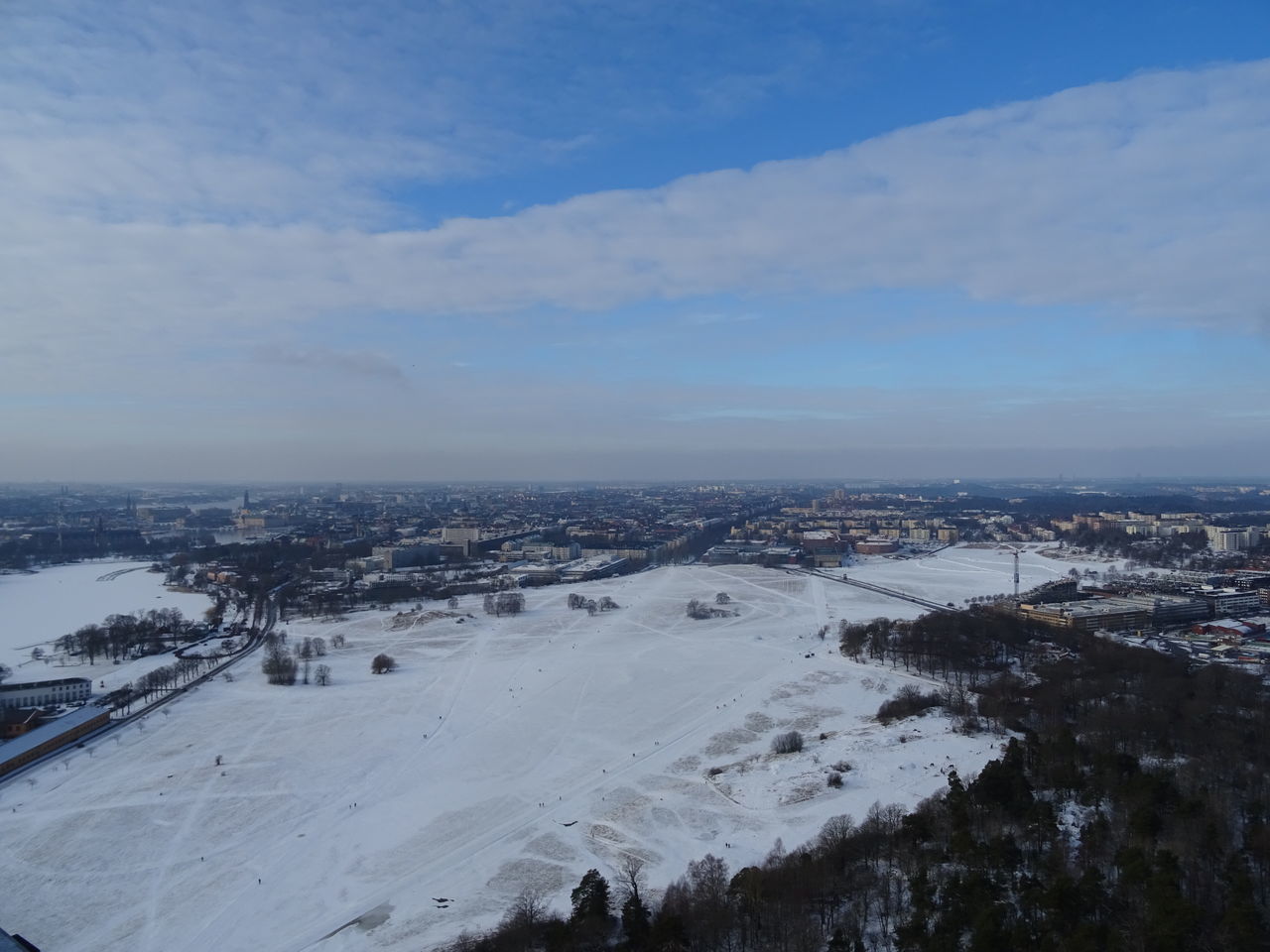 HIGH ANGLE VIEW OF CITYSCAPE AGAINST SKY