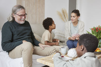 Family relaxing and playing games at home