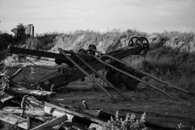 Abandoned truck on field against sky